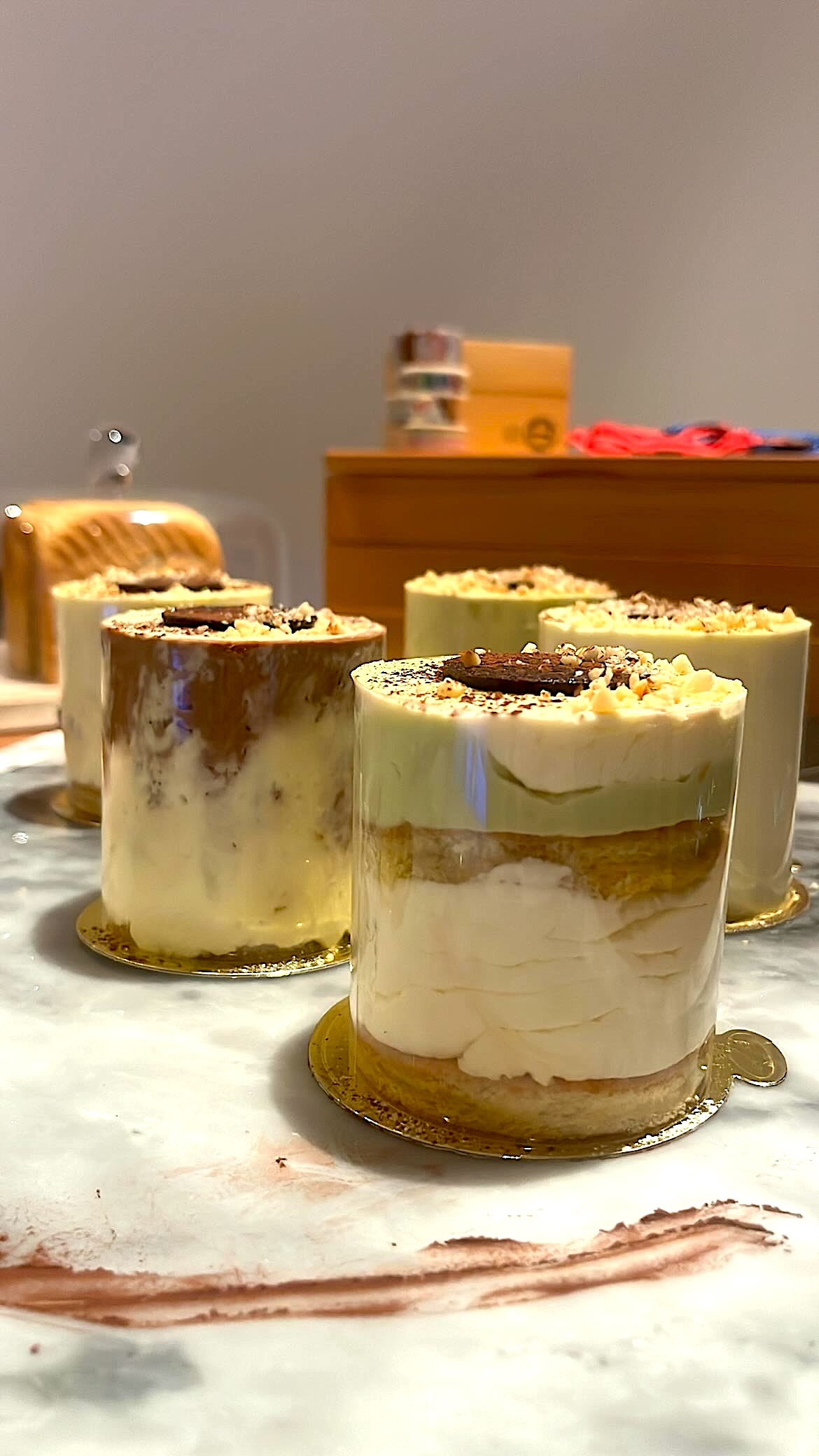 Layered cake with cream piped between layers, shaped like a cylinder